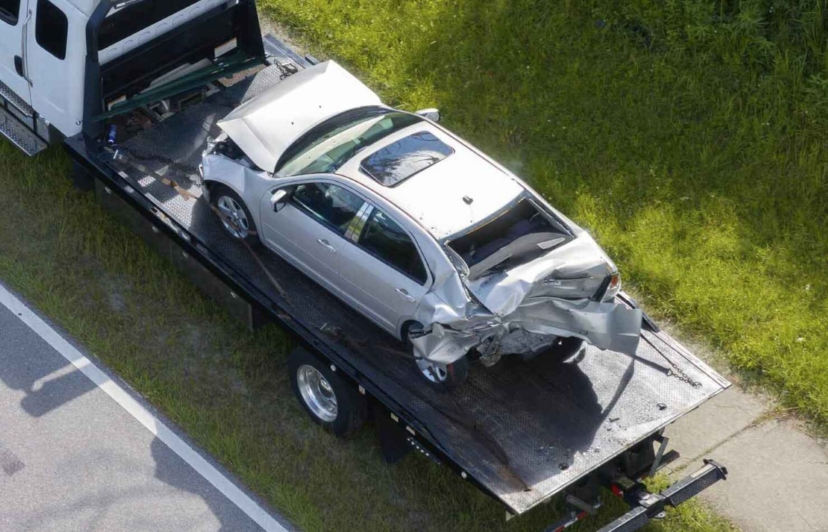 Accident recovery towing service safely transporting damaged vehicle